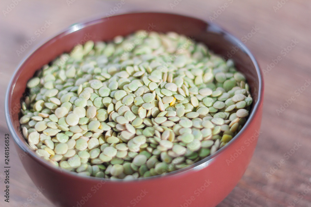 green lentils in bowl on wooden background green lentils in bowl on wooden background