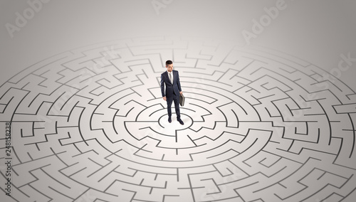 Elegant businessman looking for a solution in a middle of a maze