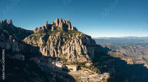 Aerial; drone view of multi-peaked mountain range; site of Benedictine abbey, Santa Maria de Montserrat; highest summit of Montserrat is Sant Jeroni; the location of the Holy Grail in Arthurian myth