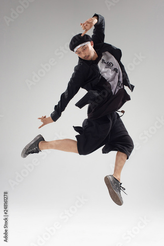 Hip hop dancers moving and jumping in photostudio
