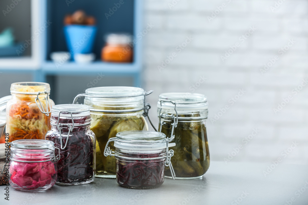 Assortment of tasty fermented vegetables on table in kitchen Assortment of tasty fermented vegetables on table in kitchen