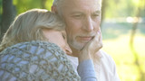 Caring woman in her 50s tenderly touching husband face, relationship and love