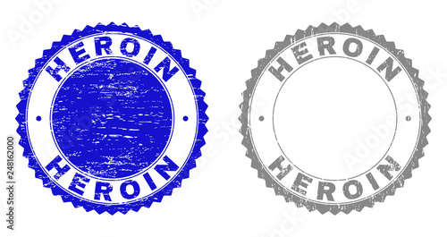 Grunge HEROIN stamp seals isolated on a white background. Rosette seals with grunge texture in blue and gray colors. Vector rubber watermark of HEROIN label inside round rosette.