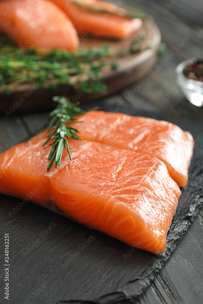 Raw salmon fillet on slate board, closeup Raw salmon fillet on slate board, closeup
