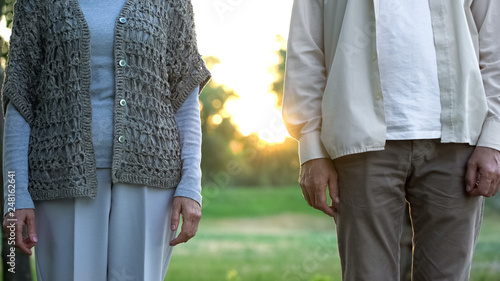 Fotografie Senior couple standing apart, medical insurance of elderly people, opinion poll