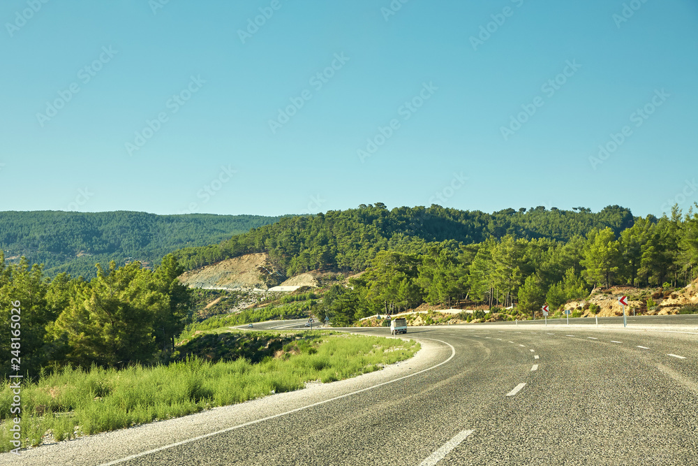picturesque mountain highway with forest. asphalt empty road