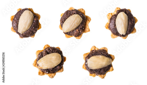 Set of sweet cupcakes with chocolate and almond. Isolated on white background. Group of yummy pastries decorated by brown cocoa filling. Cakes for wedding, Christmas and New Year celebration or party.