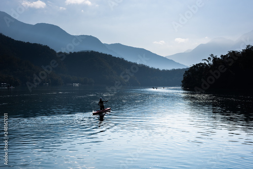 silhouette of people boating