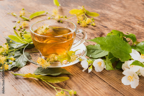 Cup of green tea linden jasmine on wooden background