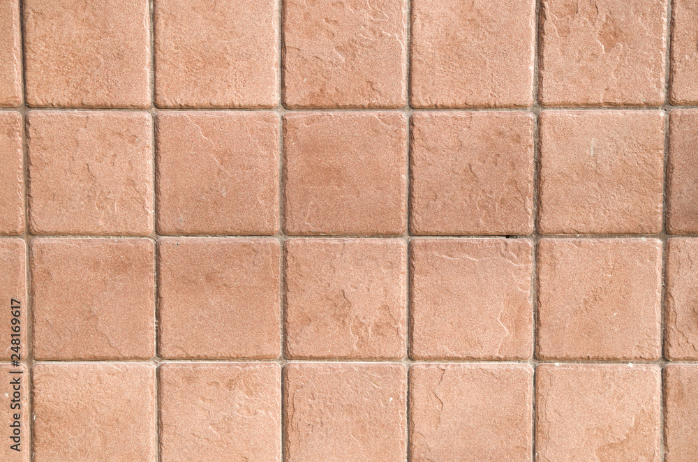 A wall lined with square ceramic tiles A wall lined with square ceramic tiles