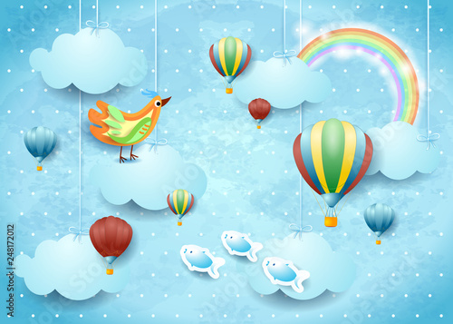 Surreal cloudscape with balloons, bird and flying fishes