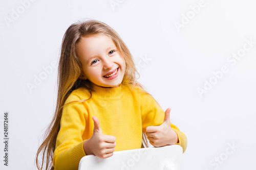 Cute girl 4-5 year old posing in studio. Original, square photo with space for text.