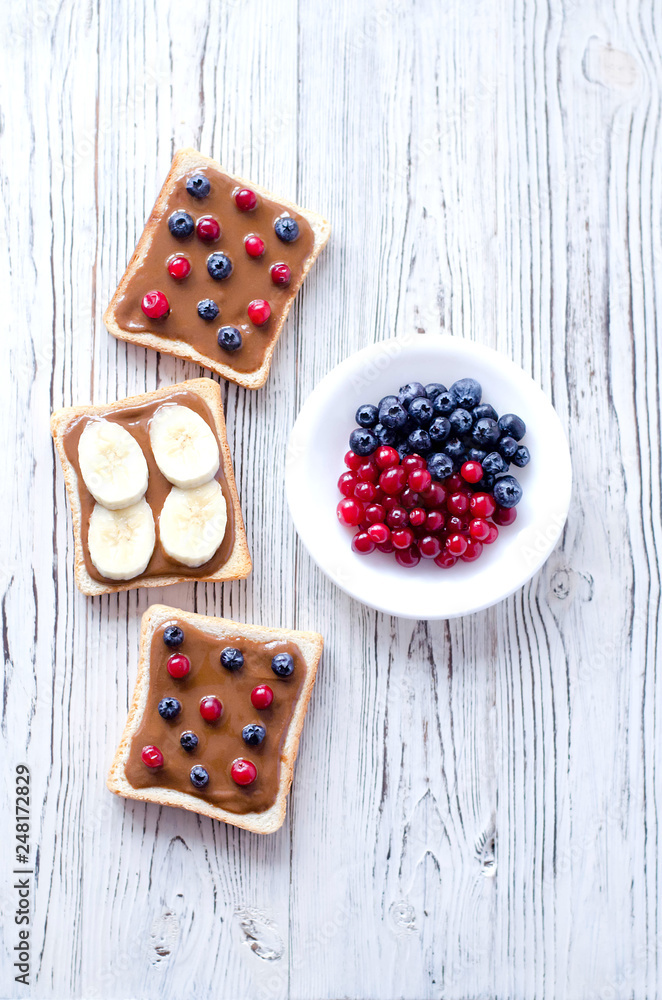 Healthy toast with peanut butter and fresh fruit. Healthy toast with peanut butter and fresh fruit.