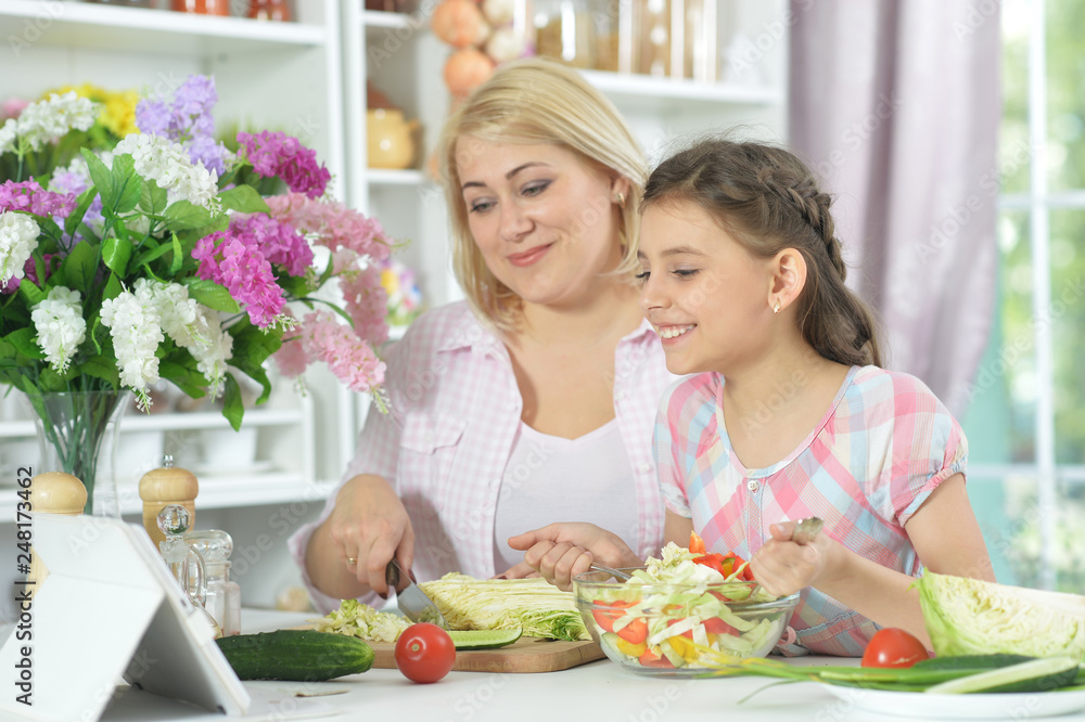 Portrait of mother and daughter cooking together Portrait of mother and daughter cooking together