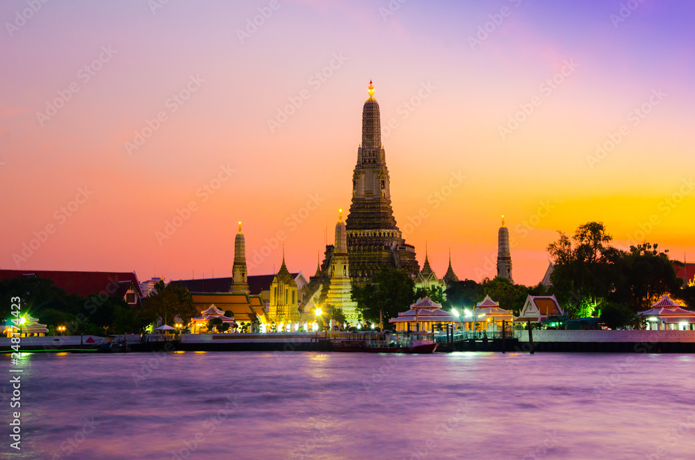 Famous wat temple in the downtown city center waterfront of Bangkok on the water river during sunset as part of children school holiday excursion exploration