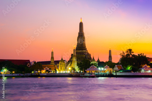 Famous wat temple in the downtown city center waterfront of Bangkok on the water river during sunset as part of children school holiday excursion exploration