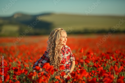 Portrait of a girl on the street with a wreath of poppy flowers on the head
