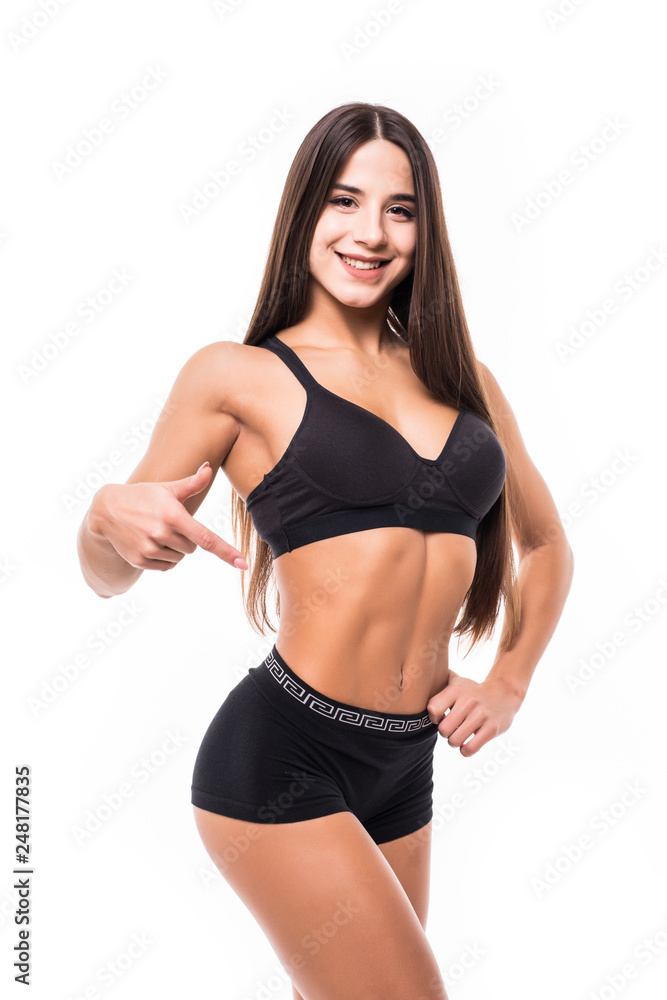 Fitness and diet concept. Beautiful sporty woman pointing at her abs isolated on white background Fitness and diet concept. Beautiful sporty woman pointing at her abs isolated on white background