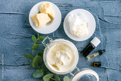 diy body butter with ingrdients on concrete background