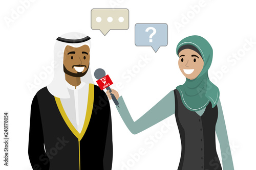 Female television reporter with microphone interviews arabic businessman