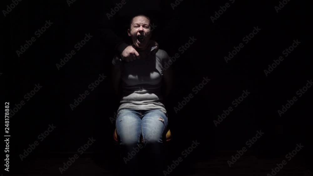 Hands killer bring knife to neck of tied woman to chair. Hands killer bring knife to neck of tied woman to chair.