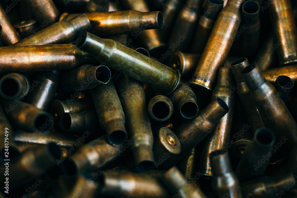 pile of used rifle cartridges 7.62 mm caliber, many empty bullet shells, assault rifle bullet shell, military background, top view pile of used rifle cartridges 7.62 mm caliber, many empty bullet shells, assault rifle bullet shell, military background, top view