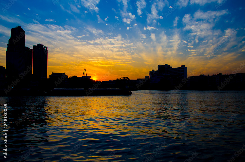 Sunset on the city center downtown river waterfront with tall building backdrop, hotel, resort, building, apartment