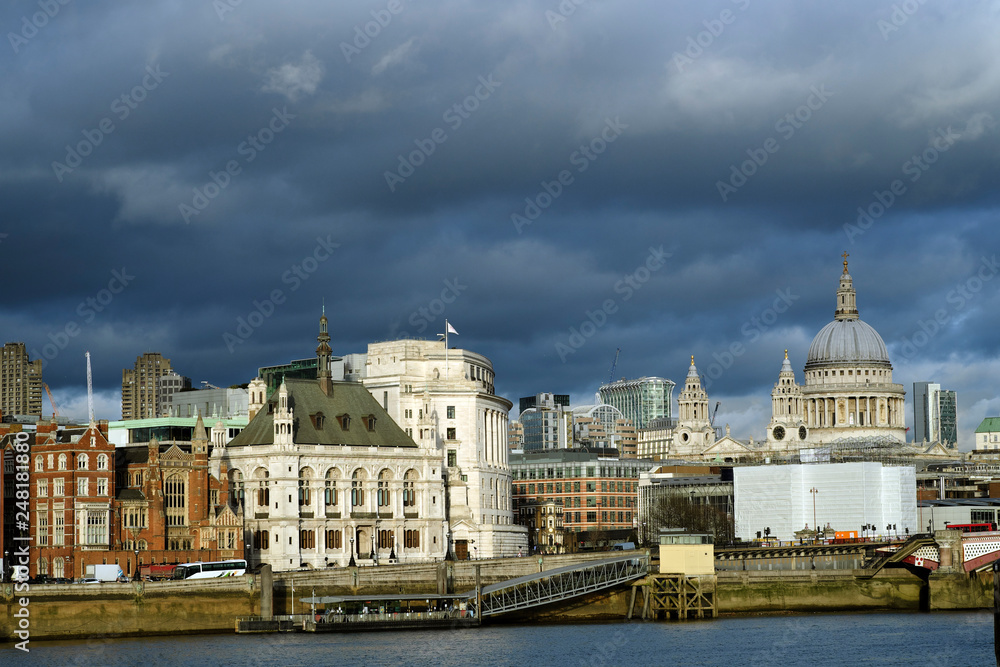 panoramic scene with old and new buildings against blue sky
