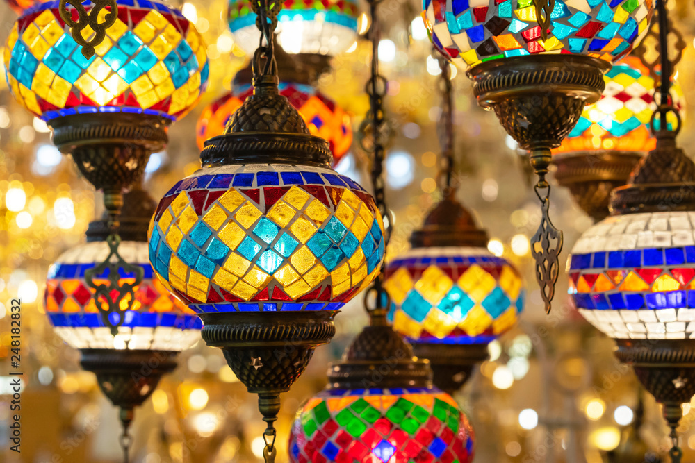 Oriental lamps from a multi-colored mosaic in the shop window.