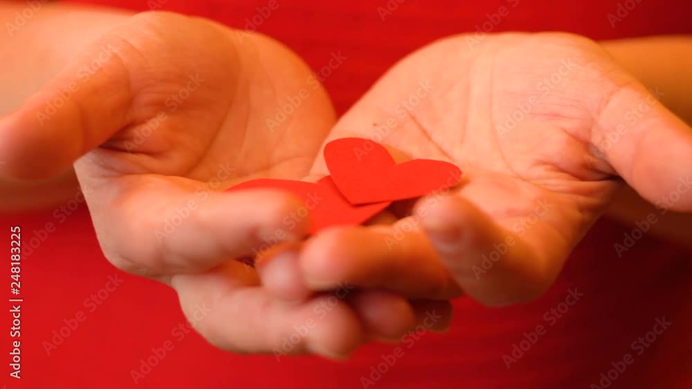 Girl holding a red heart of paper. Love for another person. Valentine's day card. Design element. Feelings and emotions. 4K video Girl holding a red heart of paper. Love for another person. Valentine's day card. Design element. Feelings and emotions. 4K video