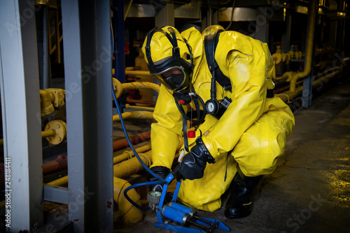 Rescuers in a radiation protection suit.