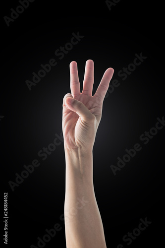 Hand up with 3 three fingers with rim light isolated on black background (clipping path)