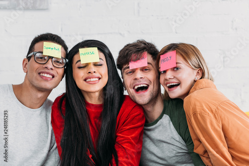 multicultural friends with funny nickname labels on foreheads