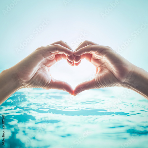 Hands in love heart shape for friendship and saving water and ocean concept