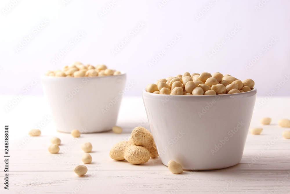 raw peeled peanuts on a light background raw peeled peanuts on a light background