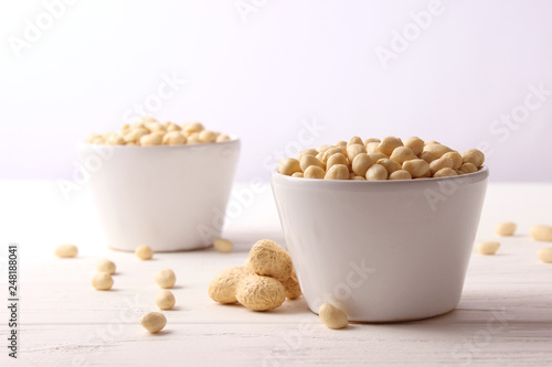 raw peeled peanuts on a light background
