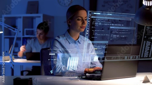 business, deadline and technology concept - businesswoman with laptop computer and virtual screen projection working at dark night office