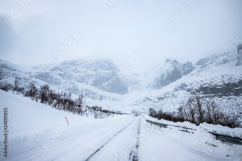  snow-covered road and mountains, Lofoten Islands, Norway