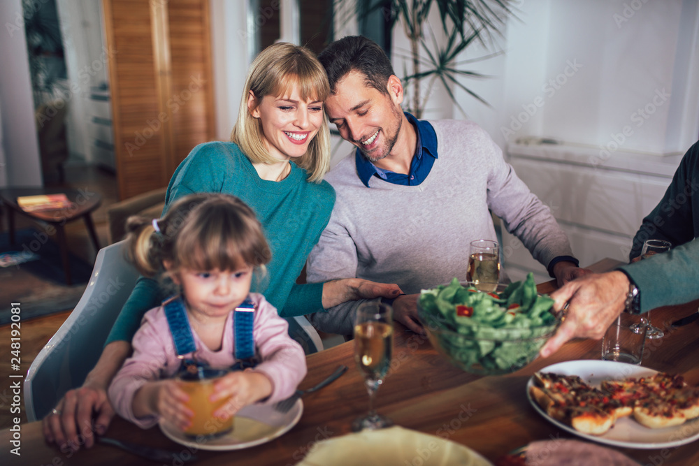 Happy family having meal in kitchen at home Happy family having meal in kitchen at home