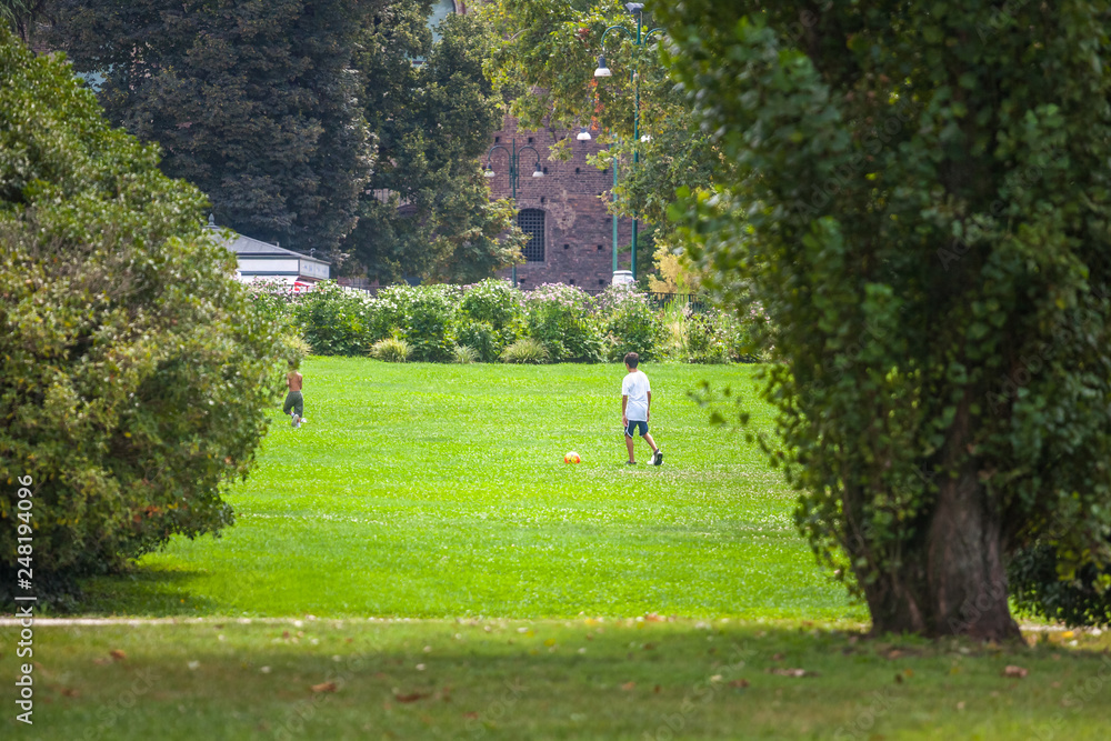 Children playing football in the famous Sempione park in milan Children playing football in the famous Sempione park in milan