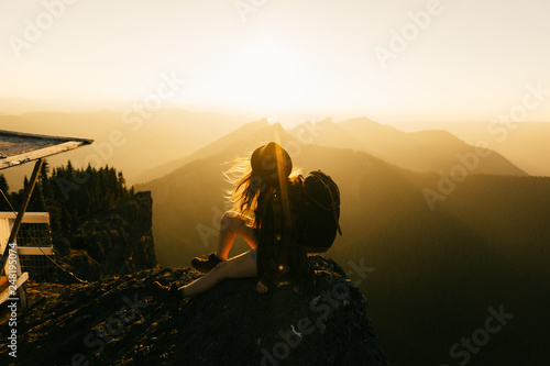 silhouette of photographer at sunset in mountains photo
