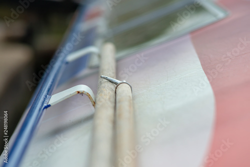 abstract close up of boat hook and pole on top of canal barge photo