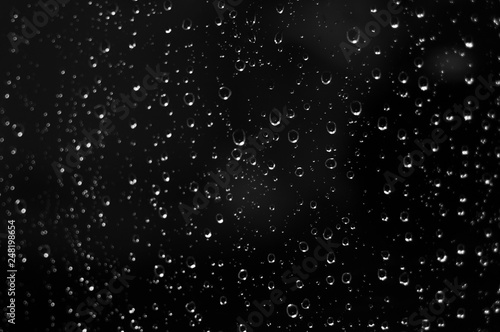 Droplets of water on black glass background