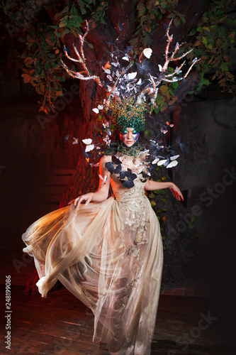 Canvastavla natural nymph with horns like branches of a tree and butterflies circling around