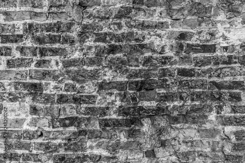 Brick wall close-up photo. Vintage textured surface with old brickwork in black and white colors
