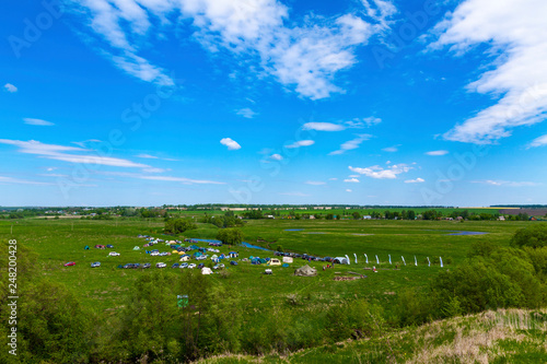 Tourist camp on the banks of the river against the blue sky. Photo from high.