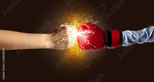 Two hands fighting with orange dust, spark, glow and smoke concept  © ra2 studio