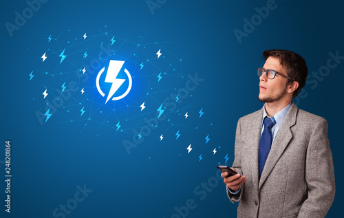 Young person using phone with power concept
 photo