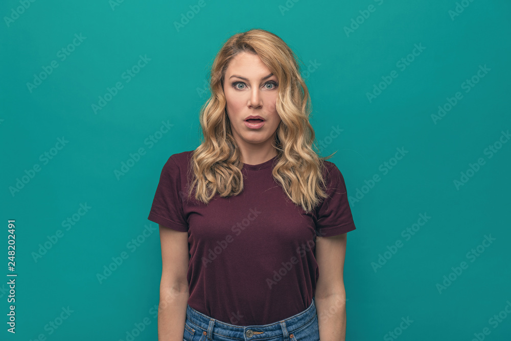 Beautiful woman with open mouth on a blue background. Beautiful woman with open mouth on a blue background.