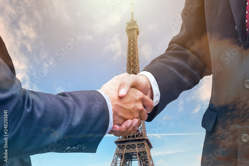 Handshake agreement of businessman with partnership on eiffel tower photo